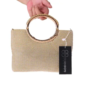 Detail view of the elegant gold rhinestone evening clutch bag with metallic round ring handle.