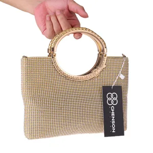 Gold rhinestone evening handbag with circular metal handle, elegant luxury clutch bag for women.