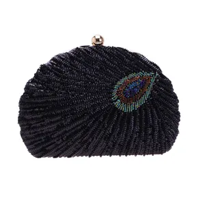 Exquisite bead embroidered peacock feather detail on black sequined evening clutch bag.