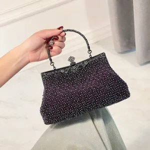 Elegant beaded evening bag with vintage metal frame, perfect for parties and weddings.