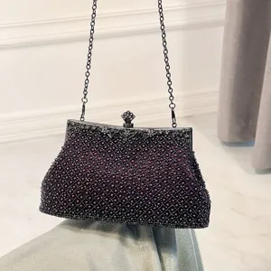 Close-up detail view of the elegant dark purple beaded evening clutch bag with chain.