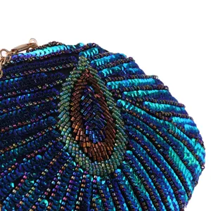 Detailed view of handmade beaded sequin evening clutch bag with exquisite peacock feather design.