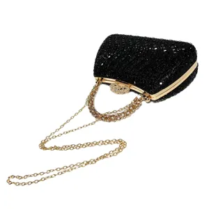 Black rhinestone evening clutch detail with gold chain strap for party cocktail weddings.