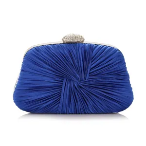 Detailed view of elegant royal blue satin pleated evening clutch with rhinestone clasp.