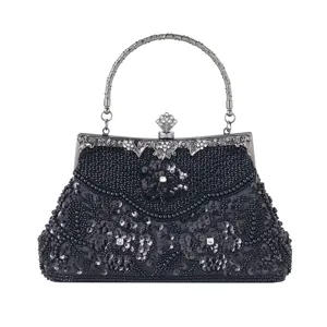 Detailed view of exquisite black beaded evening bag with sequin floral design and metal handle.
