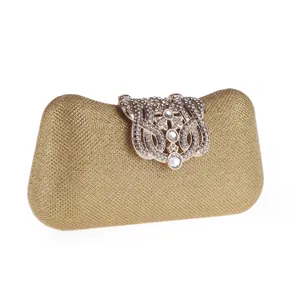 Elegant gold glitter evening clutch bag featuring a dazzling rhinestone crown buckle hard shell.