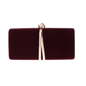 Burgundy velvet evening clutch bag with gold metal knot clasp and streamline metal decor detail.