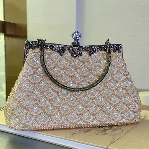 Elegant beaded evening clutch bag with fish scale embroidery and vintage metal frame lock.