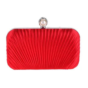 Red satin pleated evening clutch bag with elegant pearl rhinestone clasp for party wear.