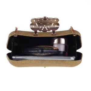 Detailed view of open gold glitter evening clutch showing spacious interior capacity with phone and cosmetics.