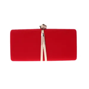 Detail view of a red velvet evening clutch bag with metal decoration for stylish women winter.