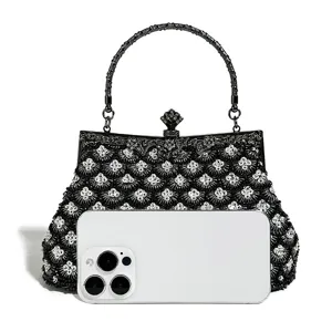 Exquisite beaded evening clutch detail, fish scale embroidery pattern, elegant metal handle.