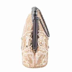 Detailed side view of luxury sequin beaded evening clutch bag with metal clasp and chain strap.