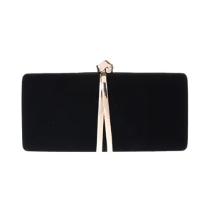 Close-up detail of black velvet evening clutch bag featuring elegant gold metal clasp hardware.