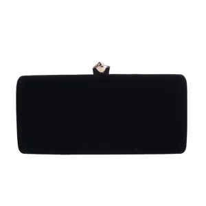 Close-up details of elegant black velvet evening clutch bag featuring premium gold metal clasp.