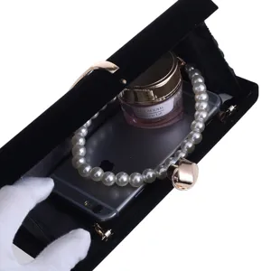 Elegant black velvet evening clutch bag with pearl handle and metal clasp for women