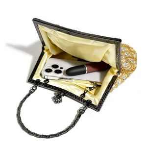 Elegant beaded evening clutch bag with metallic handle and ample inner space for essentials.