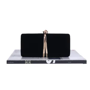 Exquisite black velvet evening clutch bag with gold metal clasp detail, elegant and chic.