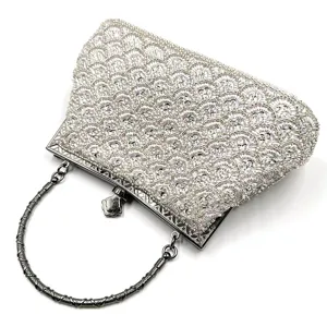 Exquisite beaded evening bag detail, sparkling fish scale embroidery with metal handle and clasp.