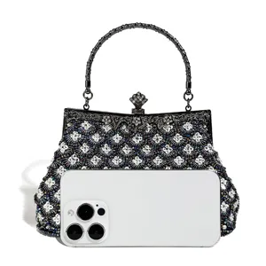 Exquisite beaded evening bag detail, featuring intricate embroidery and vintage metal handle.