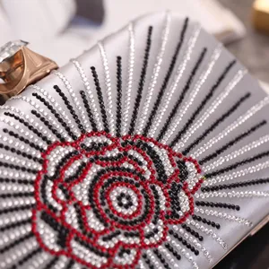 Silver rhinestone evening clutch bag with exquisite rose crystal pattern and elegant top clasp design.