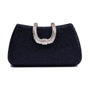 Glitter evening clutch bag detail showcasing rhinestone embellished handle for formal party wear.