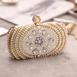 Pearl rhinestone evening clutch detail shot, elegant gold frame and crystal flower decor.
