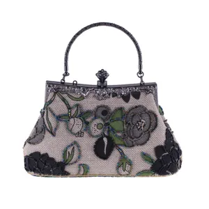Exquisite beaded floral embroidery detail on linen evening handbag, vintage metallic clasp frame.