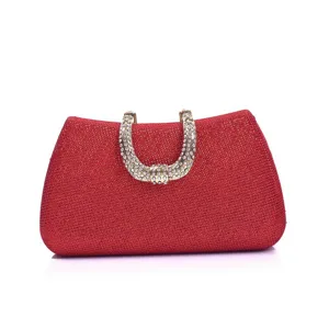 Red glitter evening clutch bag with sparkling rhinestone metal handle for party use.