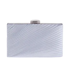 Silver pleated clutch bag detail view, elegant evening purse with sparkling rhinestone clasp.