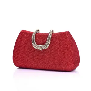 Red glitter evening clutch bag with sparkling rhinestone horseshoe handle for dress party.