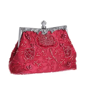 Close-up view of red satin beaded evening bag with delicate rose embroidery and silver clasp.