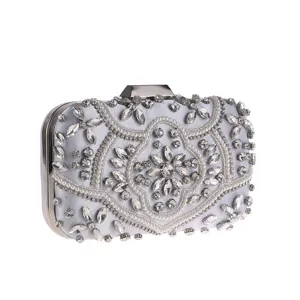 Silver rhinestone evening clutch bag with artificial pearls and metal frame for party.