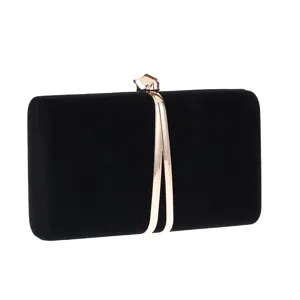 Black velvet evening clutch bag with elegant gold metallic clasp and streamlined frame detail.