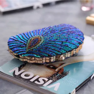 Exquisite beaded evening clutch featuring a shell shape and vibrant peacock feather sequins design.