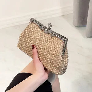 Elegant pearl evening clutch bag with metal clasp, sparkling bridal wedding party hand bag.