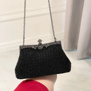 Exquisite black beaded evening clutch bag with vintage metal frame and chain strap for women.