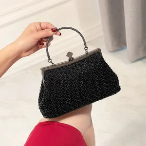 Elegant black beaded evening clutch bag with metallic clasp and handle for party wear.