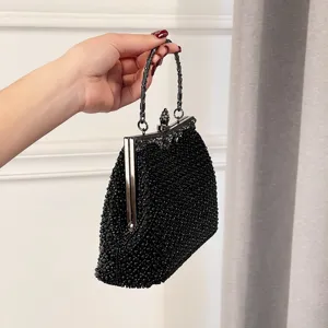 Elegant black beaded evening clutch bag featuring metal frame and stylish vintage handle