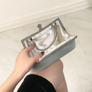Detailed view of beaded evening clutch, highlighting satin lining and silver chain detail.