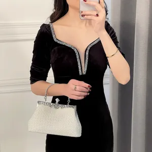 Elegant women evening bag pearl clutch paired with luxury velvet dress detail style.