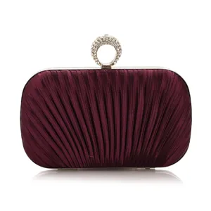 Detailed view of the purple pleated evening clutch bag with a sparkling rhinestone ring clasp.