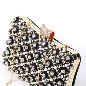 Luxury rhinestone pearl evening clutch bag detail shot, elegant black wedding party purse.