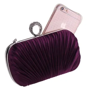 Detailed view of the purple pleated evening clutch bag with sparkling rhinestone ring clasp.