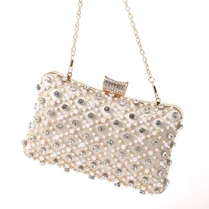 Elegant pearl and rhinestone embellished evening clutch bag detail, ideal for party.