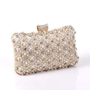 Detail view of women evening clutch bag, diamond rhinestone and pearl embellished design.