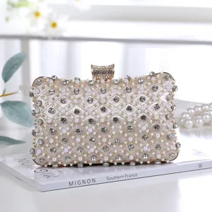 Elegant champagne satin evening clutch bag decorated with sparkling rhinestones and pearls.