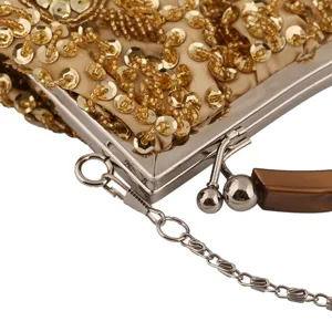Gold sequined evening bag detail, metallic clasp frame and chain strap, vintage style.