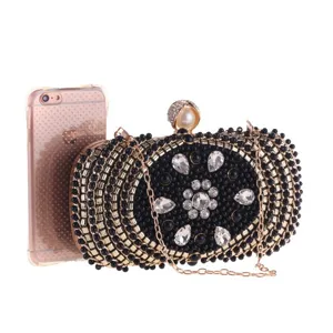 Detailed view of luxury black beaded evening clutch bag with sparkling rhinestones and gold chain.