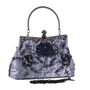 Detailed view of vintage beaded evening handbag with exquisite floral embroidery, metal frame.